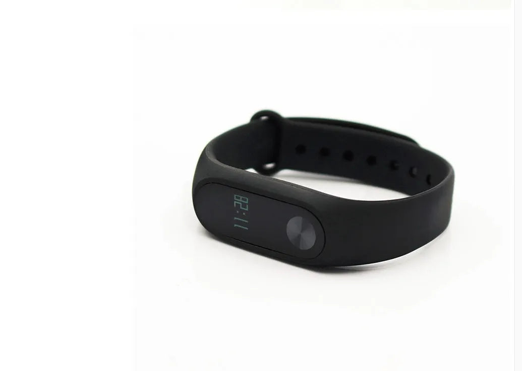 Xiaomi Mi Band 2 black fitness tracker with OLED display showing heart rate and time on adjustable wrist strap