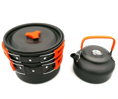 Outdoor camping cookware set with saucepan, frying pan, teapot, and stainless steel cups in mesh storage bag