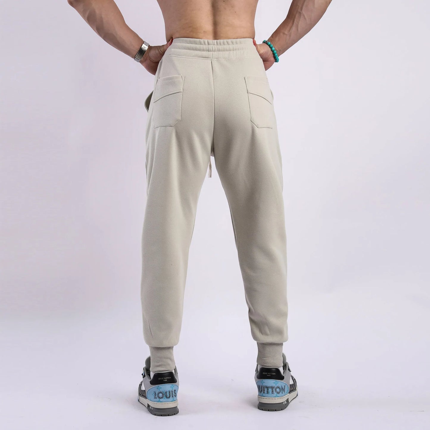 Men's casual trousers with drawstring ankle ties in polyester cotton fabric