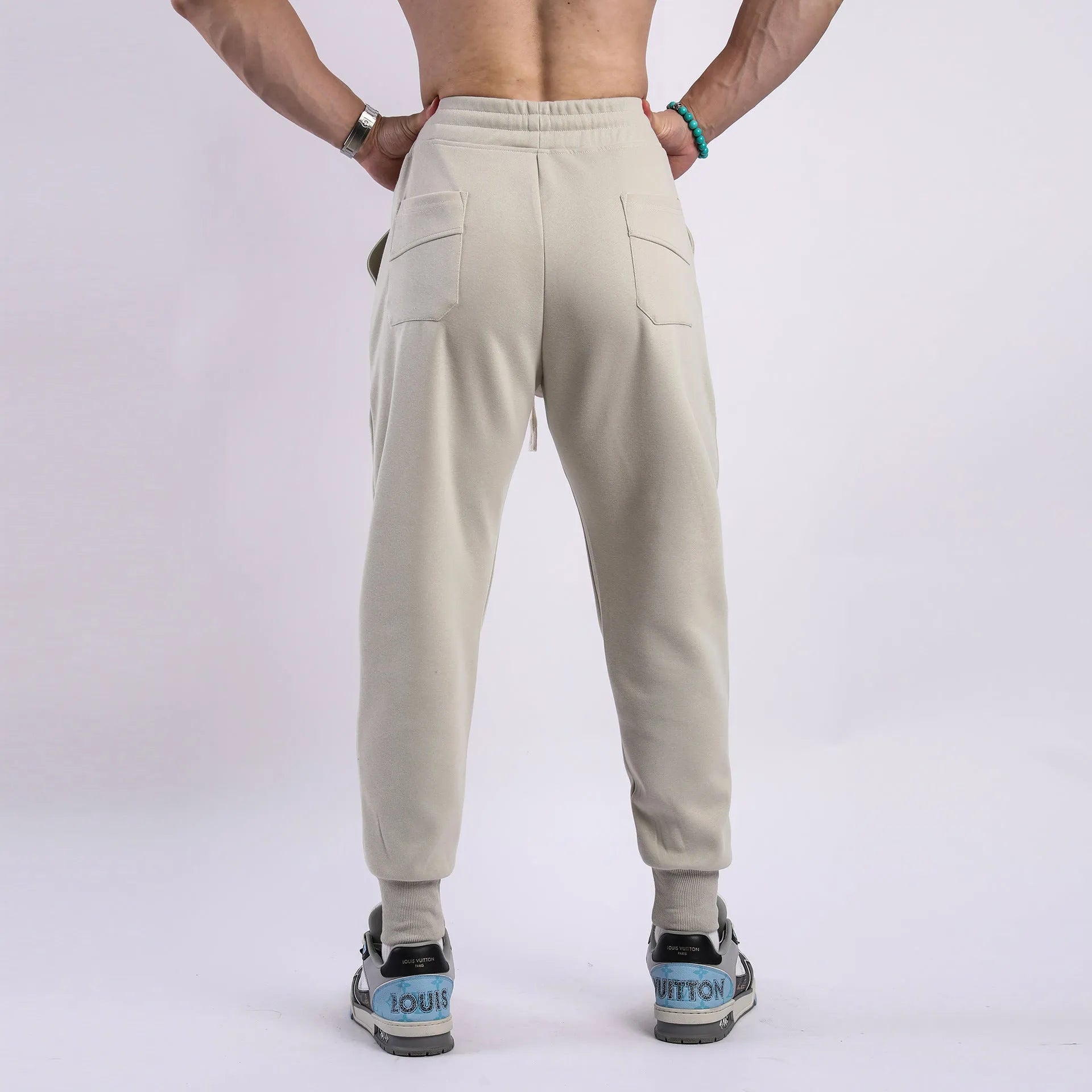 Men's casual trousers with drawstring ankle ties in polyester cotton fabric
