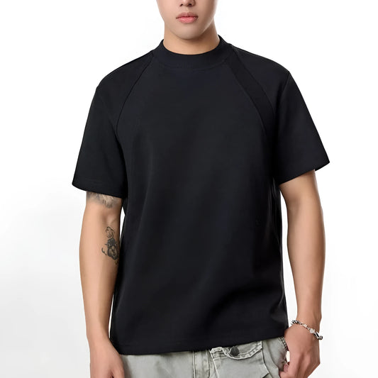 Man's loose fit black short sleeve top with textured air layer stitching detail.