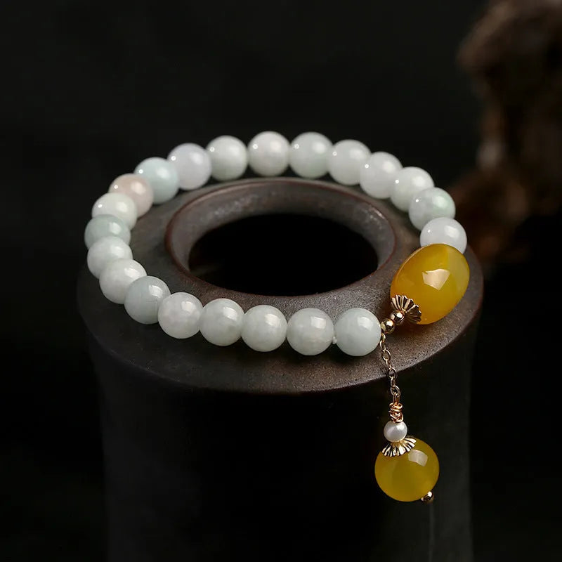 Women's ethnic bracelet with hanging red agate tassel and 14K gilded geometric design