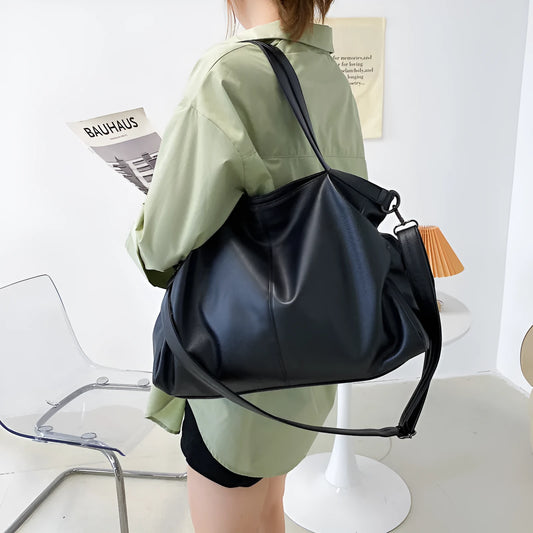 Large soft black PU messenger bag with long shoulder strap and front car suture detailing