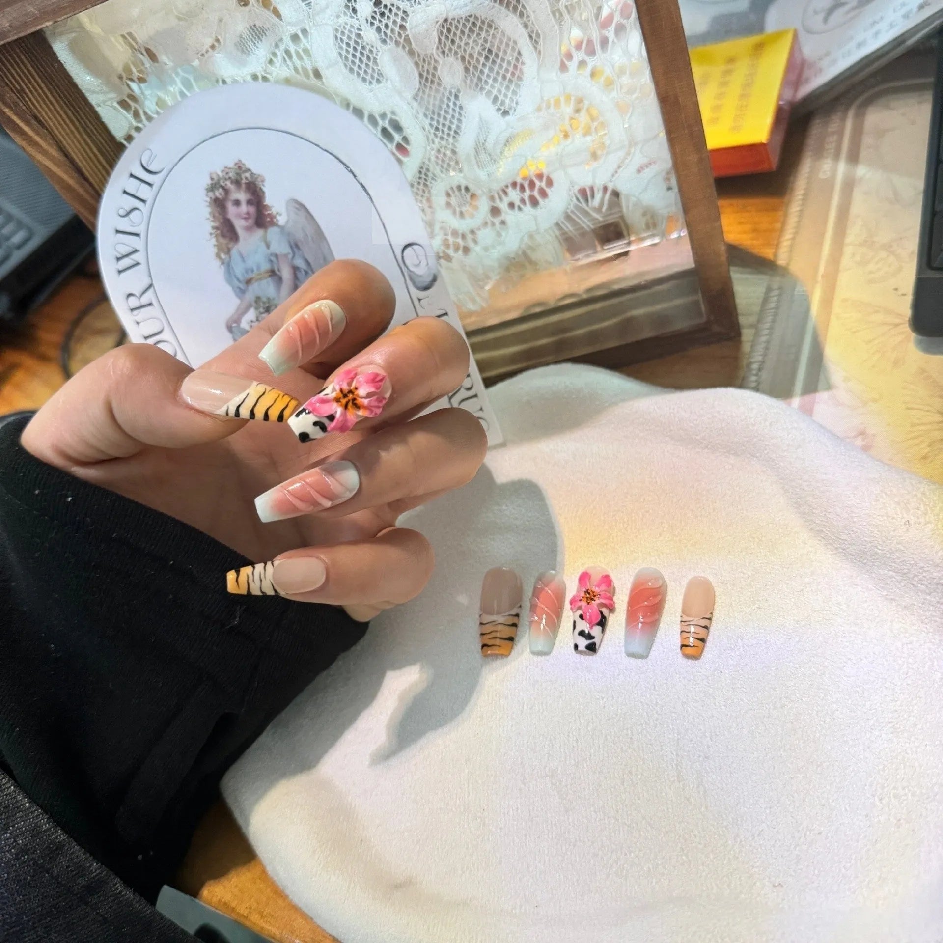 Hand-carved artificial nail art set with zebra pattern, embossed flowers, and leopard print in long length.