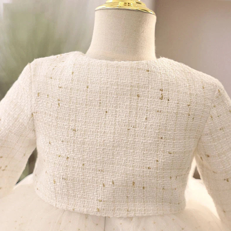 White long-sleeved flower girl wedding dress with princess styling on mannequin