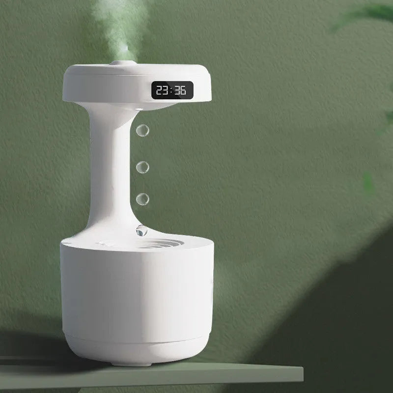 White columnar anti-gravity humidifier with LED clock display on a wooden desk