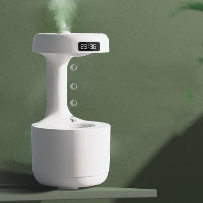White columnar anti-gravity humidifier with LED clock display on a wooden desk