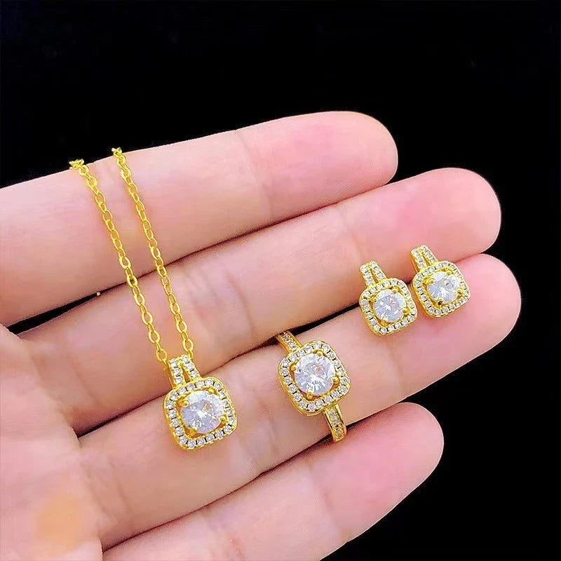 Elegant gold-toned jewelry set including necklace, earrings, and ring with zircon gemstone pendant