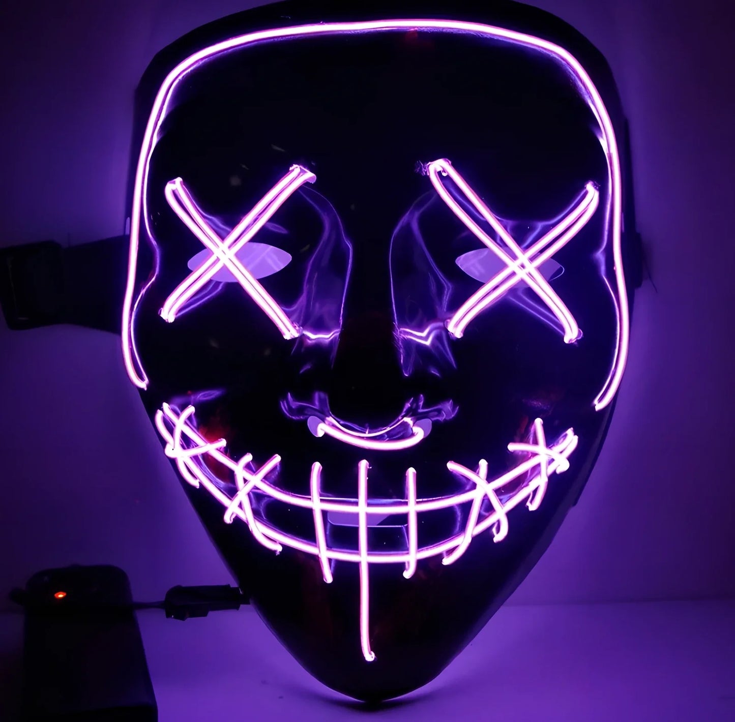Black V-shaped electroluminescent Halloween mask glowing with uniform illumination, showing folding capability and plastic construction