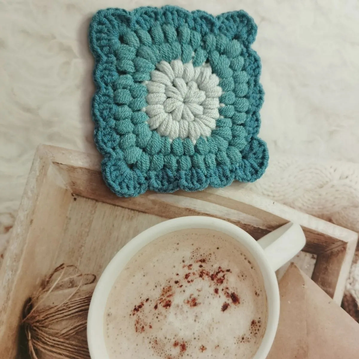 Crocheted wool cup coaster with grandmother lattice pattern in selected colour