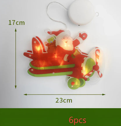 LED Christmas hanging lights with suction cups showing snowman design illuminated on window