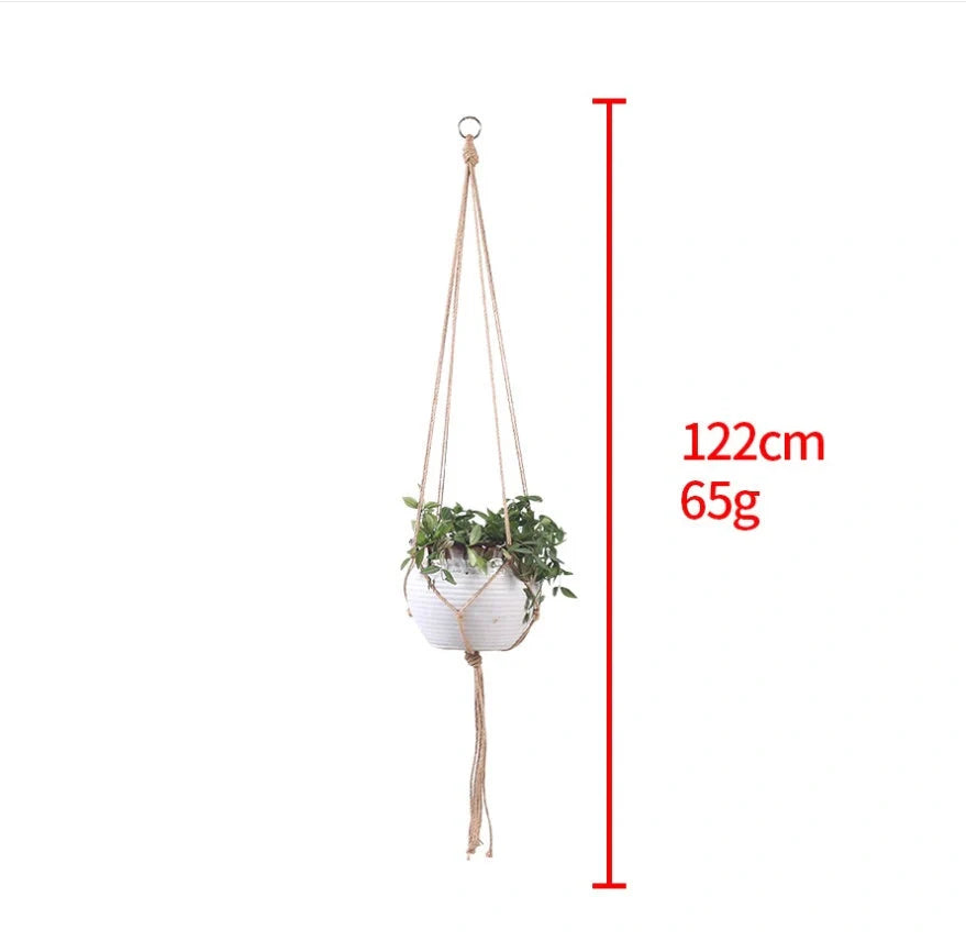 Hand-woven cotton rope hanging plant basket in natural jute, perfect for home decor.