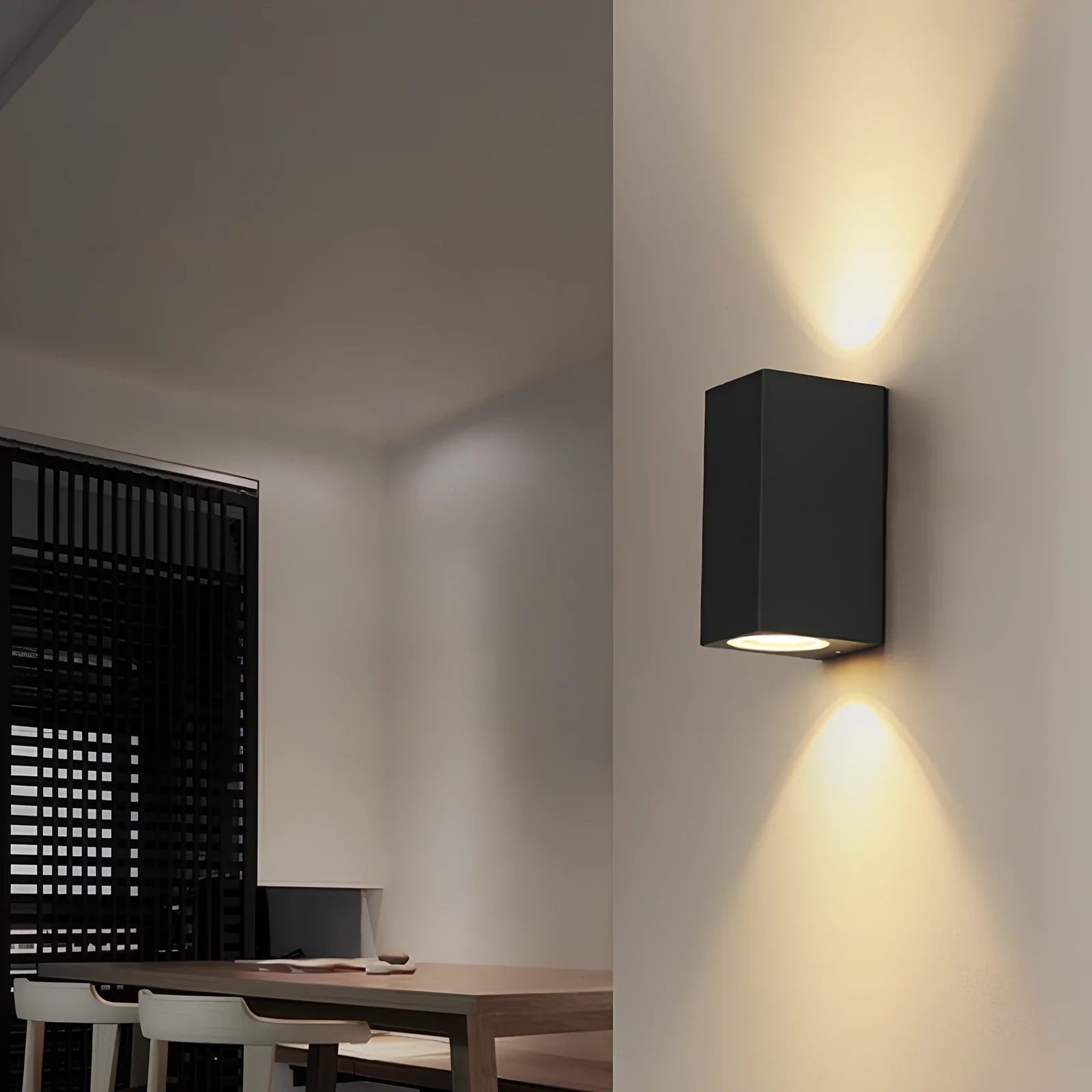 Black aluminium LED wall lamp with tempered glass shade mounted on white wall