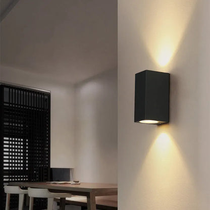 Black LED wall lamp with aluminium body and glass shade mounted on wall