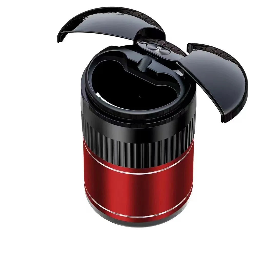 Compact black metal car ashtray with automatic lid on a car console