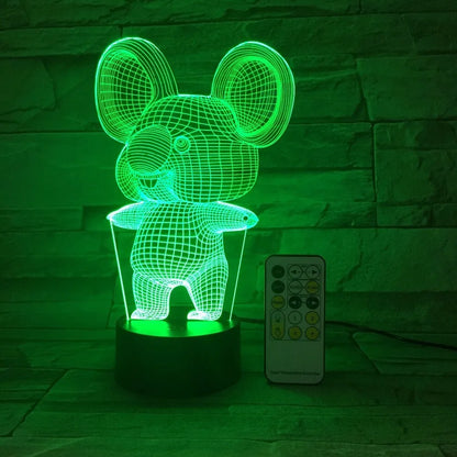 Black Koala night light with LED illumination on a bedside table.