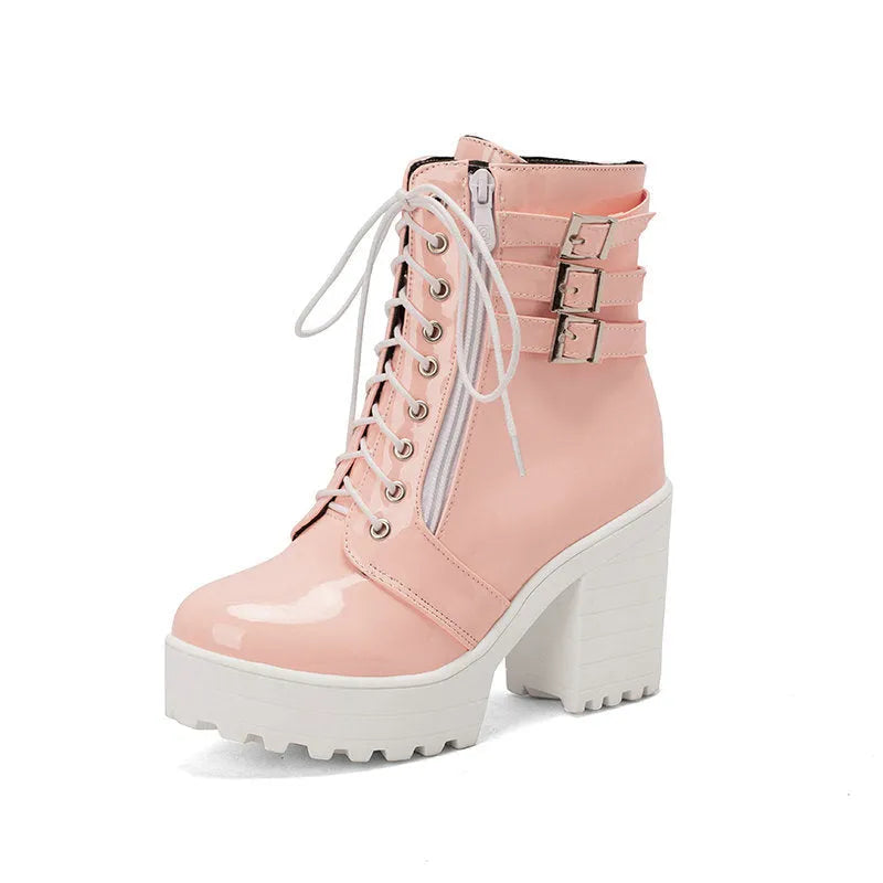 Women's black lace-up ankle boots with a round toe and thick 6-8cm platform heel on a wooden floor.