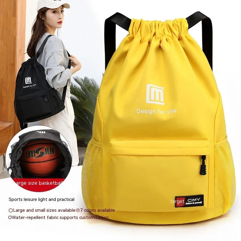 Large bucket-shaped travel backpack in blue with drawstring closure and soft black shoulder straps.