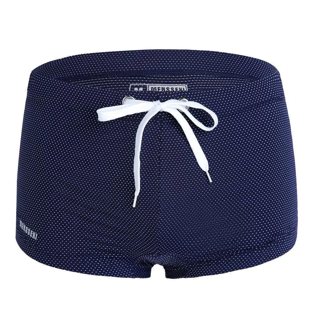 Men's low waist boxer style swimming trunks in nylon, available in multiple solid colours.