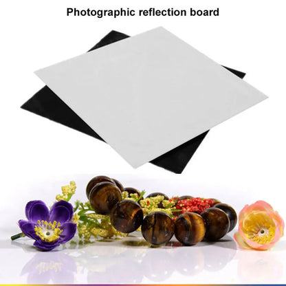 Square black and white acrylic reflection boards for product photography on a table