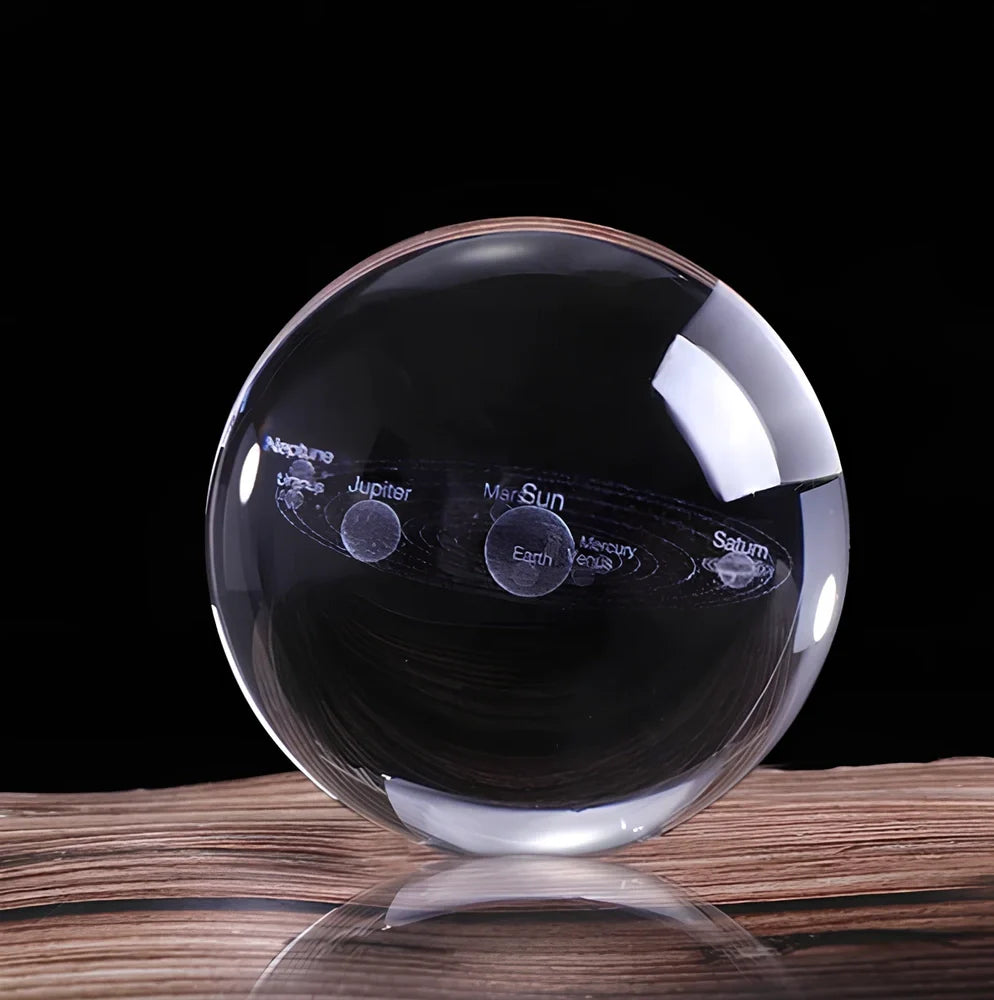 Solar system crystal ball showing planets inside K9 optical crystal sphere on metallic base