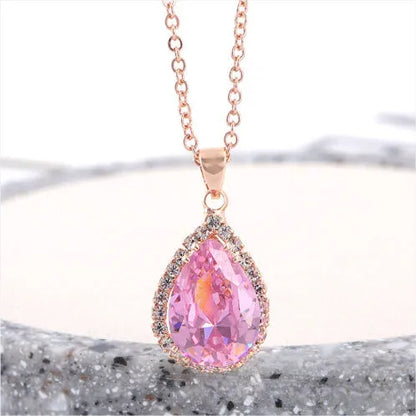 Rose gold geometric water drop pendant necklace on a model, showing adjustable chain and sparkling stone inlay.