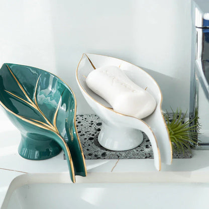 Elegant ceramic soap dish with leaf-shaped design, suction cup, and drainage holes for bathroom and kitchen use