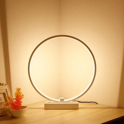 White circular LED bedside lamp with 25cm diameter on iron base showing warm white illumination