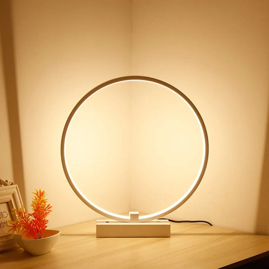 White circular LED bedside lamp with 25cm diameter on iron base showing warm white illumination