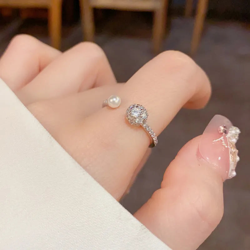 Open-end pearl ring with round zircon stones on geometric copper band with gold plating