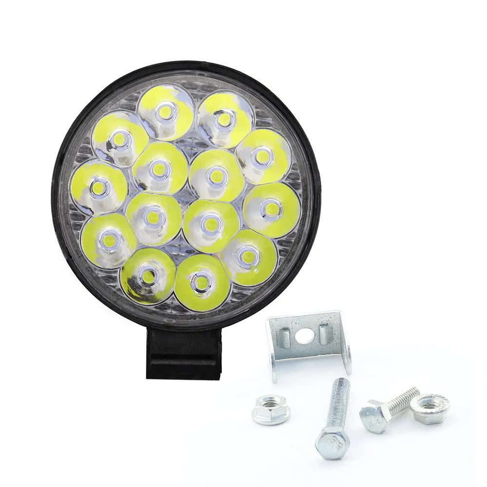 Small round white aluminium LED work light with IP67 rating for automotive use.