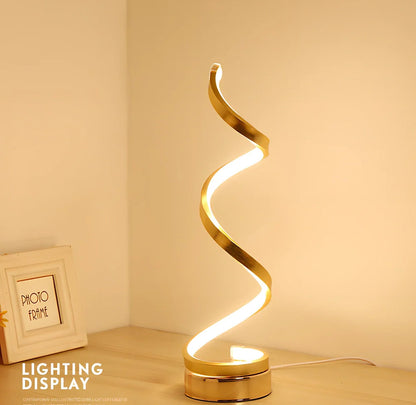 Modern table lamp with curved design, metal base, and acrylic shade offering remote-controlled dimming between warm and white light