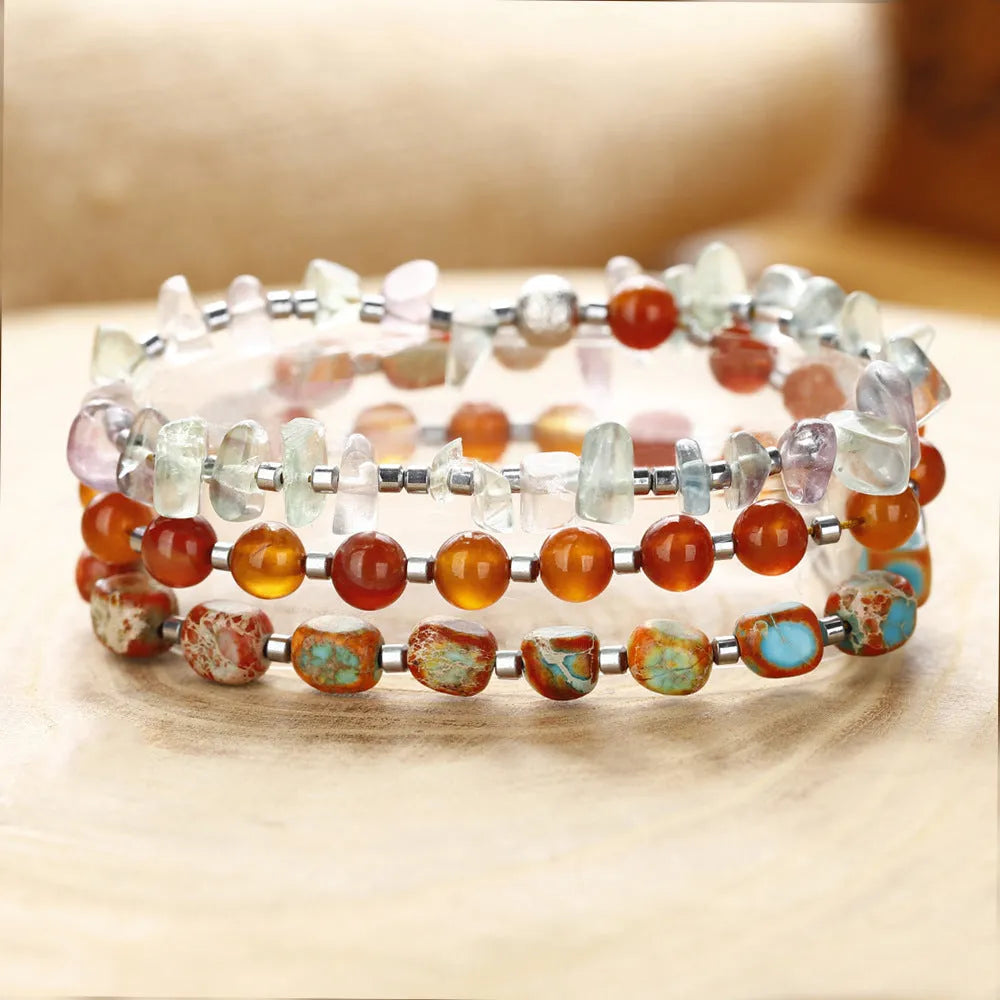 Hand-woven red agate round beads bracelet with geometric shapes and textured surfaces