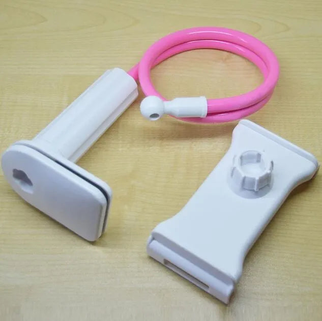 Bedside oversize flat panel handset with long arm holding a mobile phone on a table