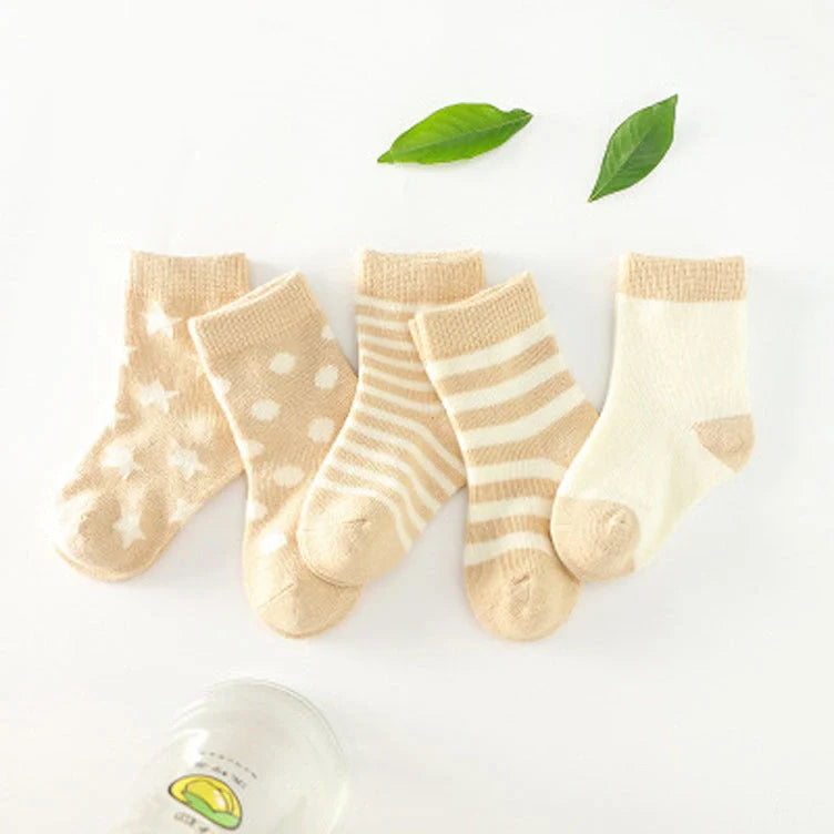 A group of colorful cotton tube socks in various sizes and patterns, designed for children's comfort and style.
