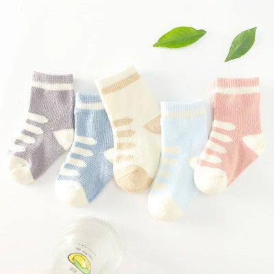 A group of colorful cotton tube socks in various sizes and patterns, designed for children's comfort and style.