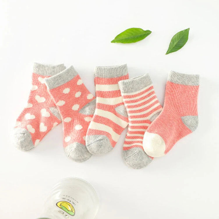 A group of colorful cotton tube socks in various sizes and patterns, designed for children's comfort and style.