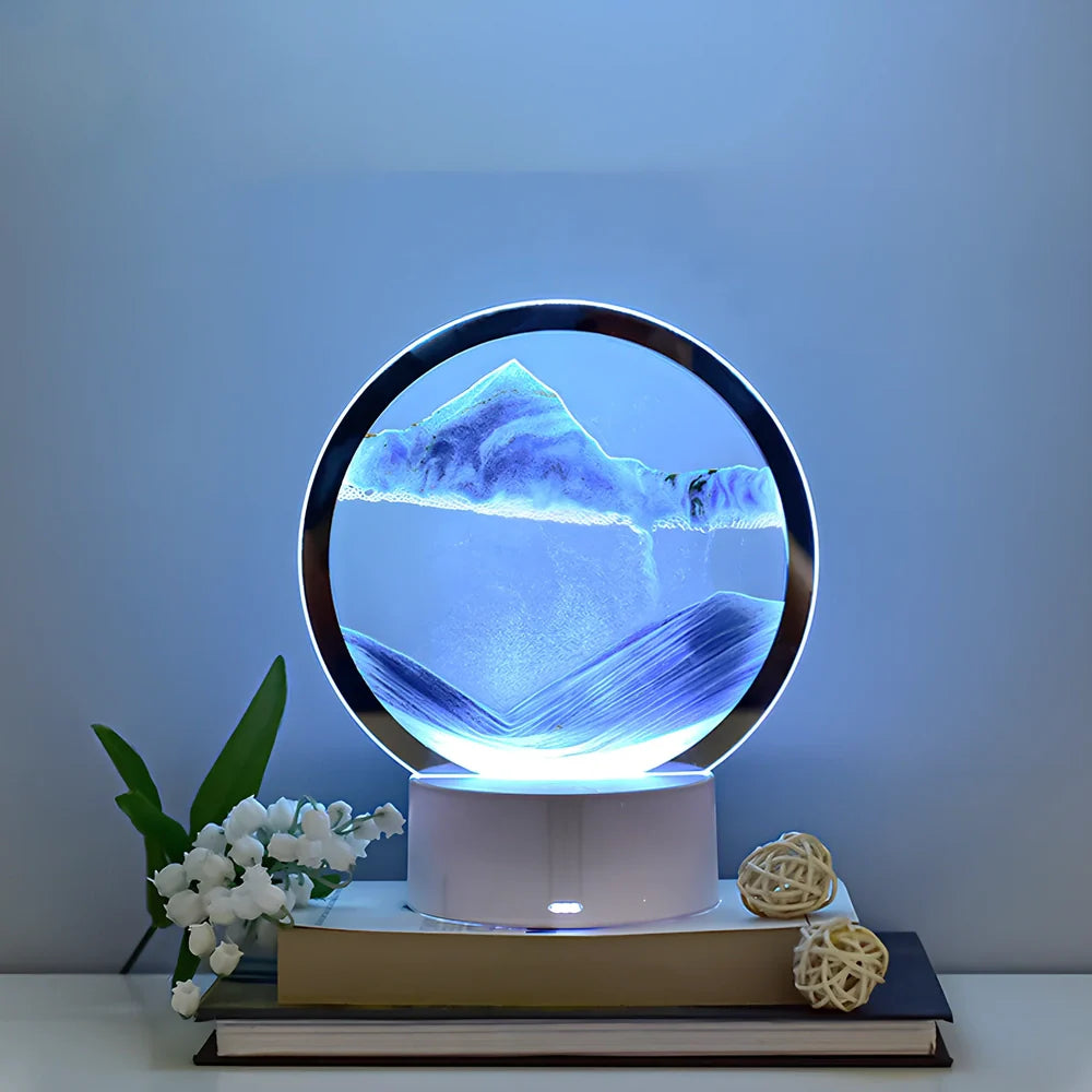 Desktop hourglass lamp with colourful LED lighting illuminating flowing quicksand patterns