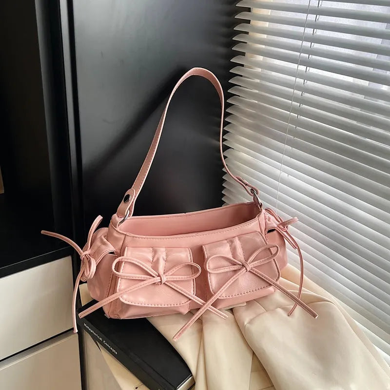 Women's tassel bow shoulder bag in pleated design with multiple pockets, shown in a selected colour.