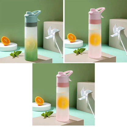 Large plastic spray water bottle with handle strap and leakproof lid in green colour.