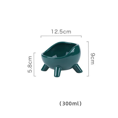 Green ceramic cat food bowl with four legs and elevated design for stable feeding