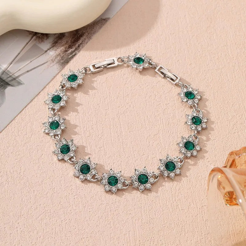 Floral shaped zinc alloy bracelet with electroplated colourful gem finishes in gold and silver tones.