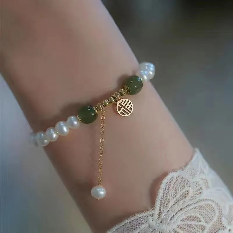 Chinese style glass bead bracelet with bamboo joint design on wrist.