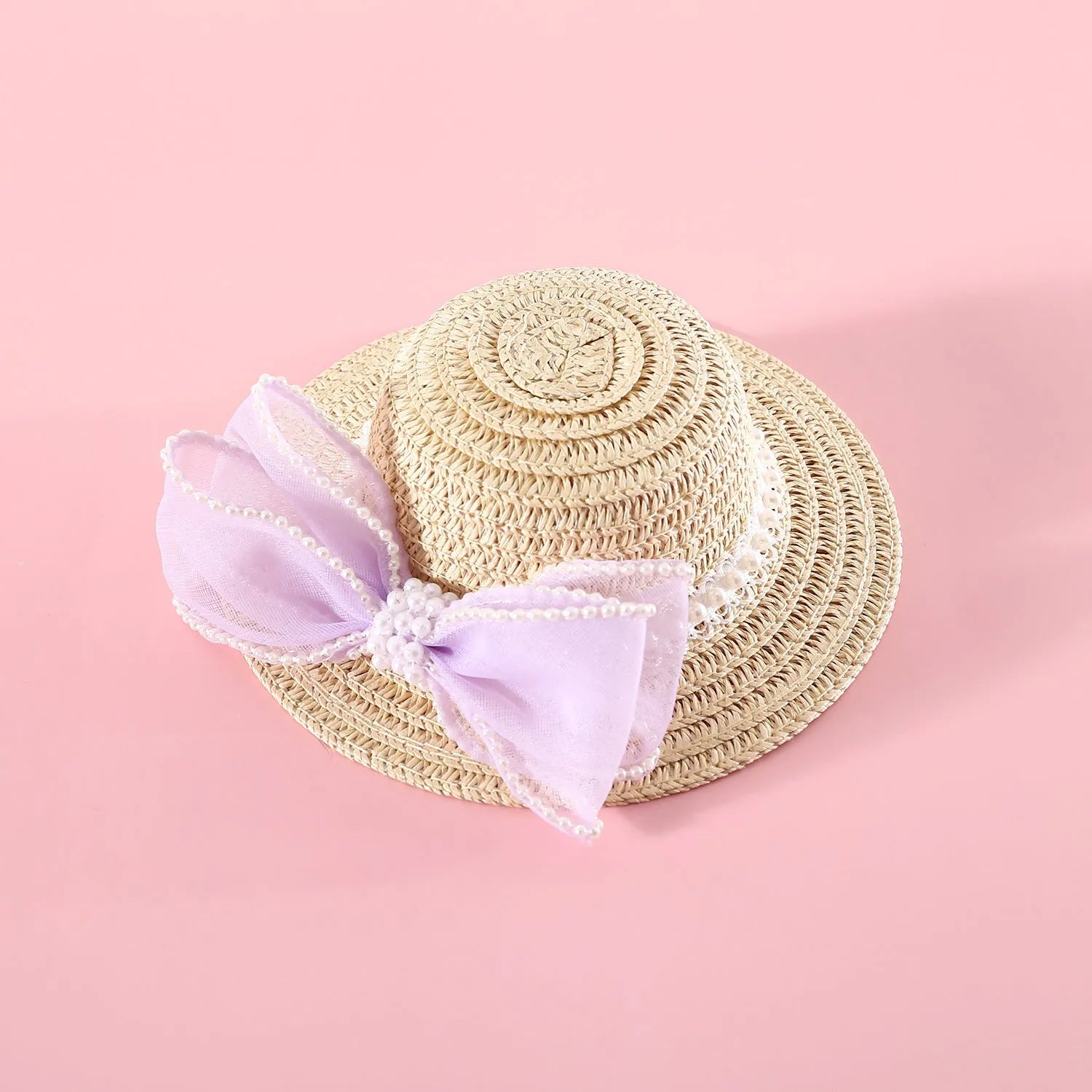 A woven Lafite leaf hat for cats with a pearl butterfly bow, shown in pink, purple, blue, and white colour options.