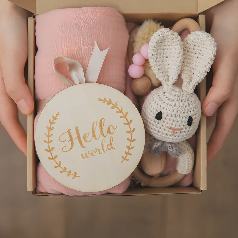 Six wooden animal bath toys floating in water with blue, brown and peach colour options