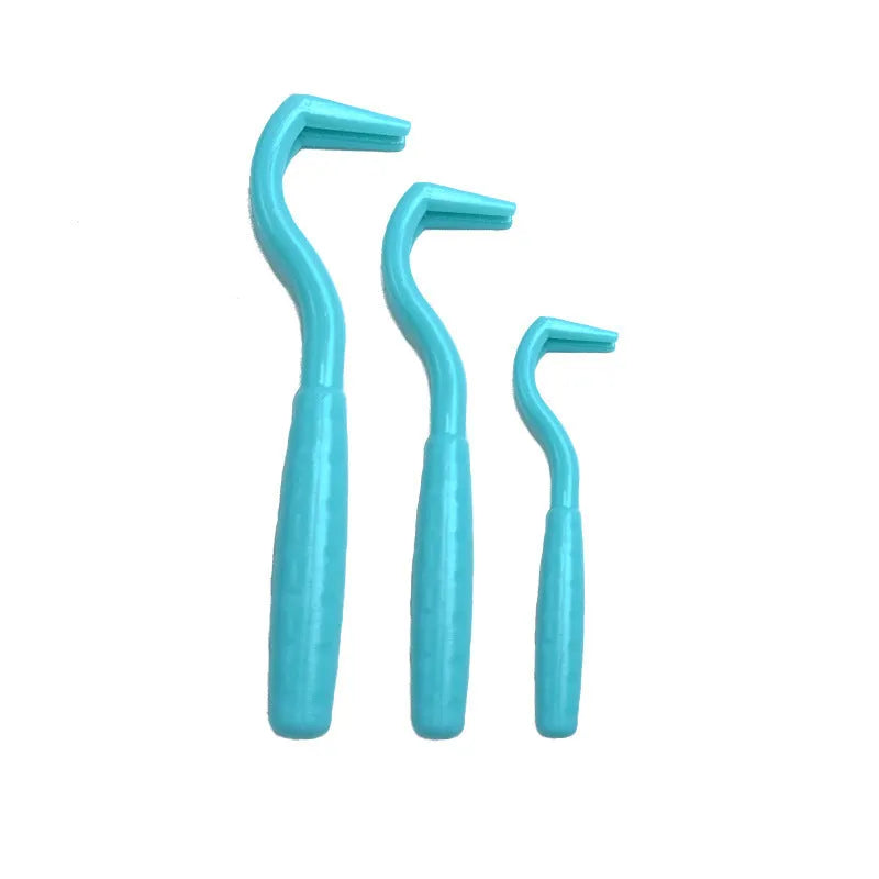 Set of three coloured tick hook removal tools for dogs on a white background.
