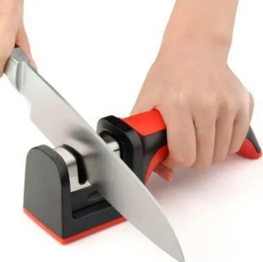 Black manual knife sharpener with three tungsten wire slots and rubber feet on base