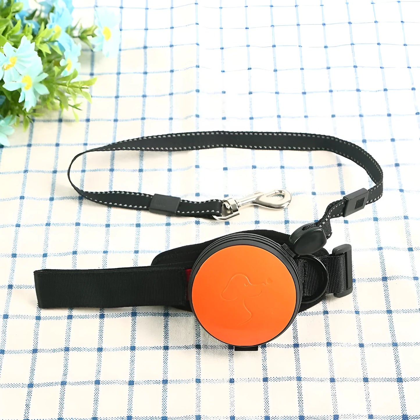 Automatic retractable dog leash extended to 3 metres with a lock button, shown in vibrant orange.