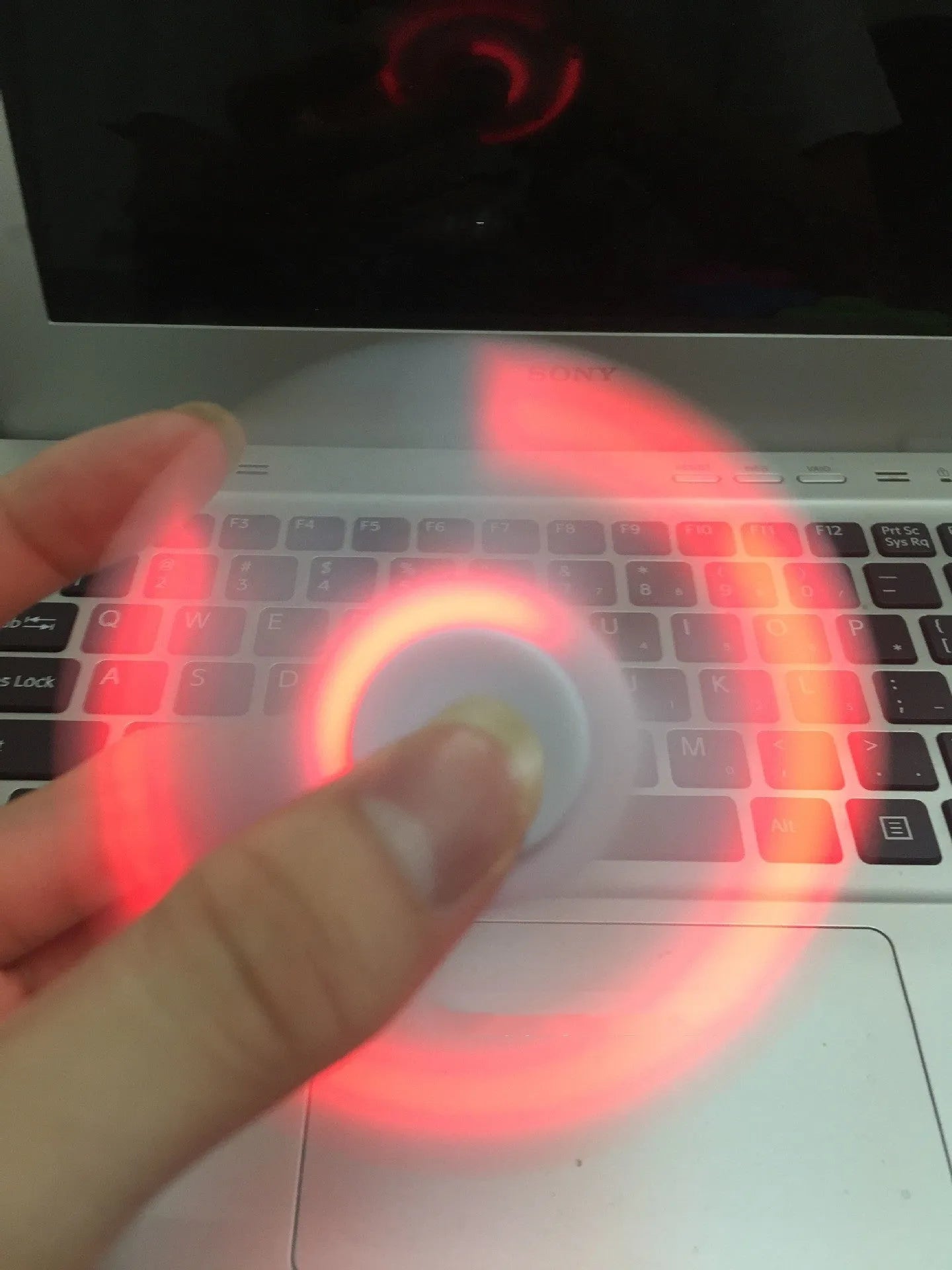 White Bluetooth speaker fidget spinner EDC toy with MP3 player functionality showing compact design