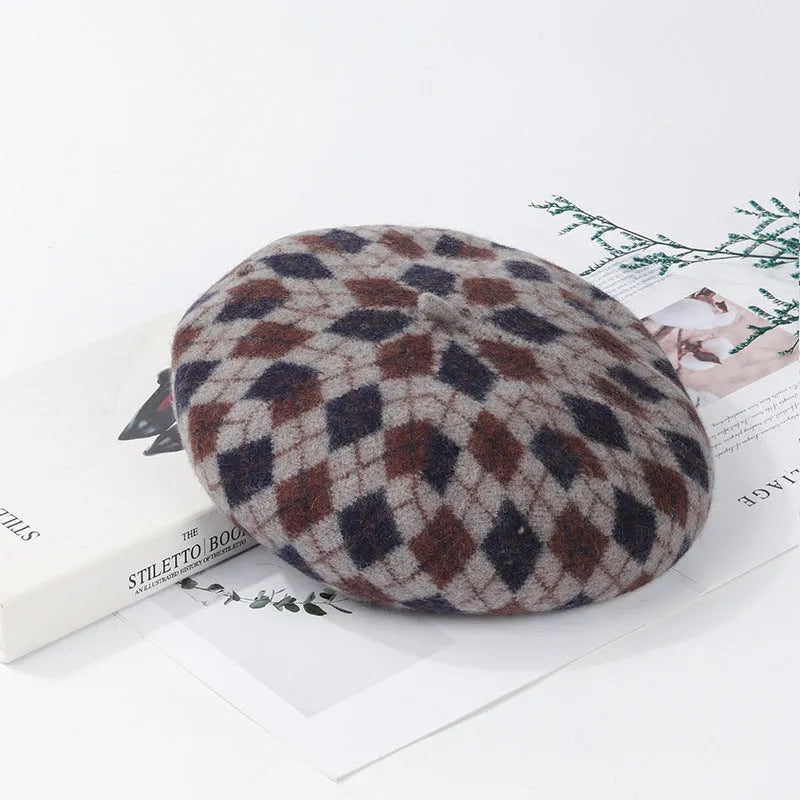 Wool plaid beret with dome crown, adjustable size, and tassel and mesh detail in blue light coffee plaid.